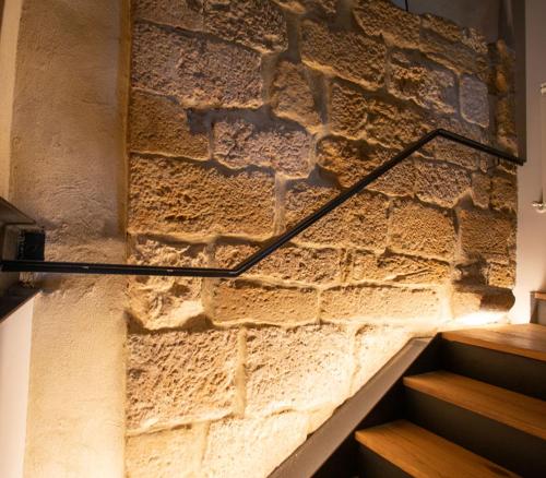 a stone wall with a staircase in a building at La Casa de los Mil Años in Estella