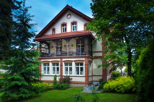 a large house with a balcony on top of it at Lawenda Apartamenty Boutique in Kudowa-Zdrój