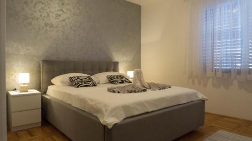 a bed with two pillows on it in a bedroom at Apartment Maša in Trebinje