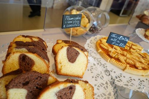 a display of breads and pies on a table at Hotel Life in Rimini