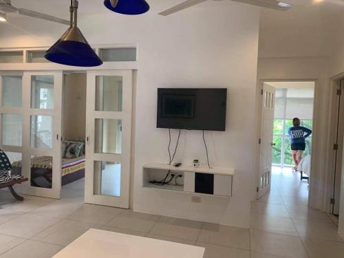 a living room with a flat screen tv on the wall at Creys Condo 2 at Pico de Loro Cove in Nasugbu