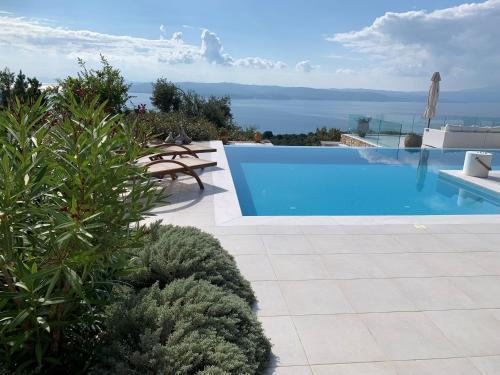 a swimming pool on the side of a villa at Villa Salina Luxury Pool Villa in Kechria