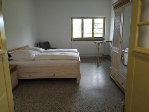 a bedroom with a bed and a window at Bahnhof Hohen Mistorf in Hohen Mistorf
