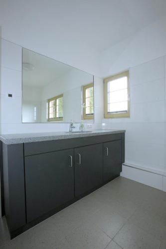 a bathroom with a sink and a large mirror at Bahnhof Hohen Mistorf in Hohen Mistorf