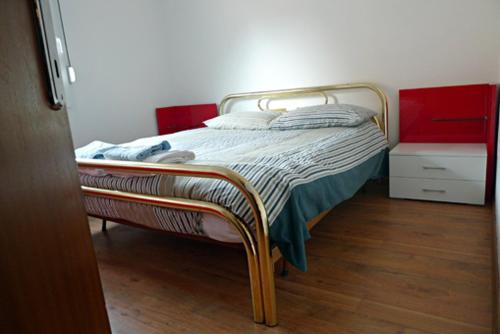 a bed sitting in a room with a wooden floor at Apartment Mars in Bovec