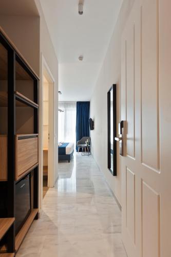 a hallway with a door and a living room at Trendy Hotel by Athens Prime Hotels in Athens