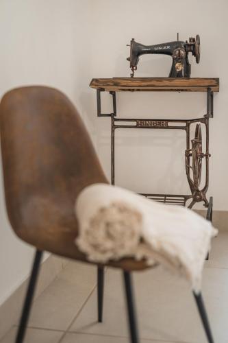 a chair with a sewing machine on a table at Cala Cala Rooms,Restaurant & Farm Experience in Procida