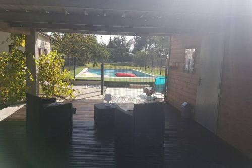 a view of a swimming pool from the inside of a house at Villa Monplaisir 82 in Montech