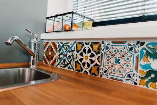 a kitchen counter with a sink and a tile back splash at Ubi-iter? History, heritage and hospitality in Doesburg