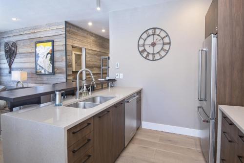 a kitchen with a sink and a clock on the wall at Sun Vail 14A condo in Vail