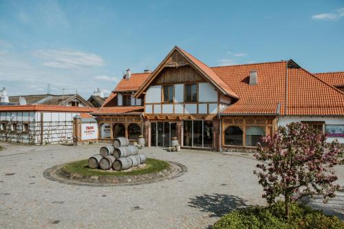 a large house with a courtyard in front of it at Hotel Głęboczek Vine Resort& Spa in Wielki Głęboczek