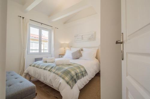 une chambre blanche avec un lit et une fenêtre dans l'établissement Sunlight Properties - 