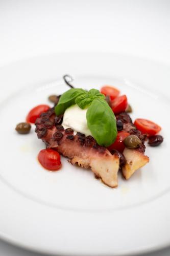 a plate of food with meat and vegetables on it at Albergo Ristorante Belvedere in Tricesimo