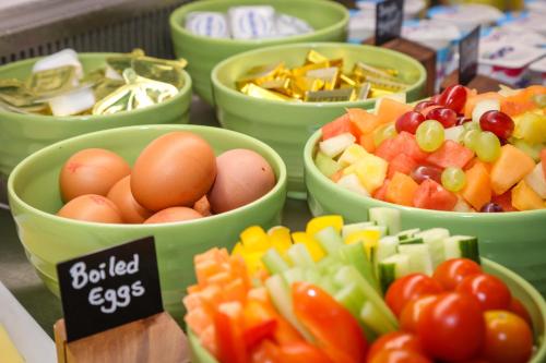 a bunch of bowls of fruit and vegetables on a table at Holiday Inn Bournemouth by IHG in Bournemouth