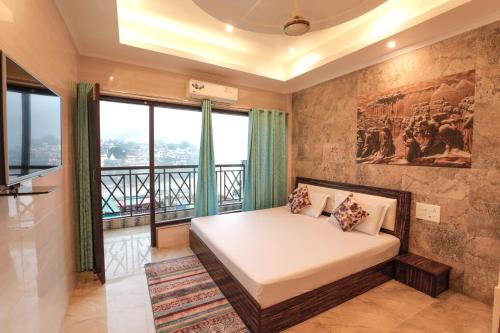 a bedroom with a bed and a large window at Hotel Grand Galaxy in Rishīkesh
