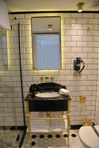 a bathroom with a sink and a mirror at A11 HOTEL Exclusive in Istanbul