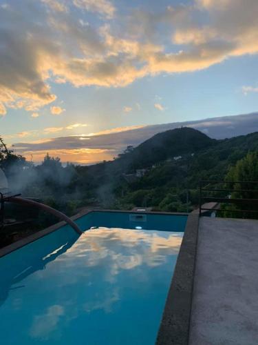 a swimming pool with a view of a mountain at Aldeia Dos Caldeirões in São Mateus