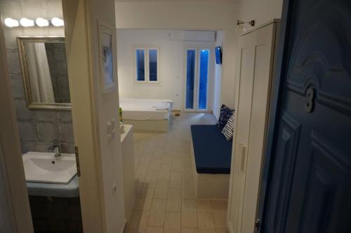 a bathroom with a sink and a toilet and a tub at Aiolos Studios Κythnos in Kithnos