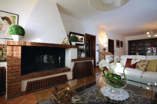 a living room with a fireplace and a couch at Agriturismo - B&B L'Acquacotta in Castiglione della Pescaia