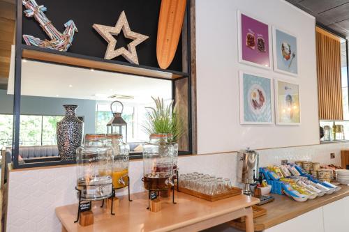 a counter with several glass vases on it at Holiday Inn Bournemouth by IHG in Bournemouth