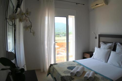 a bedroom with a bed and a large window at Mare D'Oro in Sarti