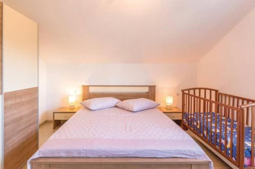 a bedroom with a bed with two pillows at VILLA NICOLE, Makarska - Poljica in Imotski