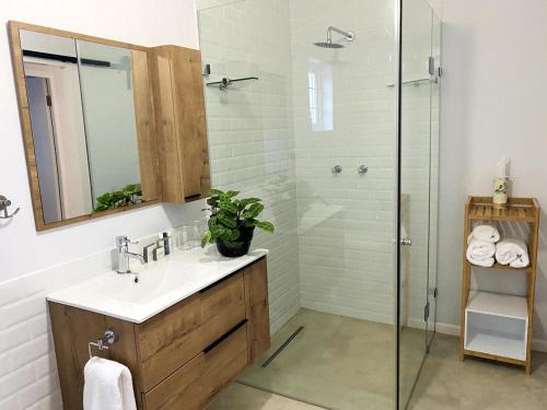 a bathroom with a sink and a shower at Daisy Cottage in Hermanus