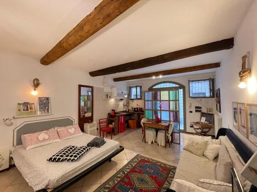 a bedroom with a bed and a living room at La casa degli zii in Ferrara