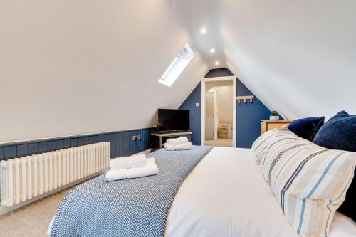 a bedroom with a large bed with towels on it at Castle View by Coast & Country Stays in Bamburgh