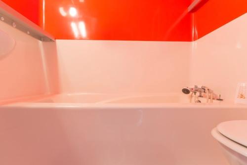 a bathroom with a toilet and a sink and a tub at travelski home classic - Résidence les Lauzières in Arc 1800