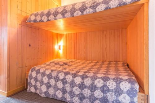 a bed in a room with a bunk bed at travelski home classic - Résidence les Lauzières in Arc 1800