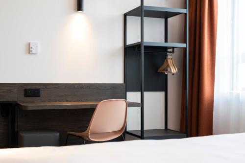 a hotel room with a bed and a desk at B&B Hotel Antwerpen Centrum in Antwerp