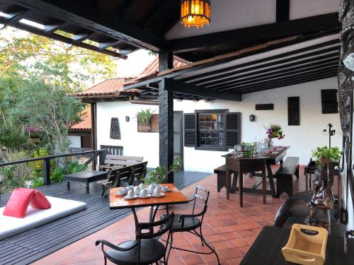 een terras met tafels en stoelen bij Pousada do Adriano in Búzios