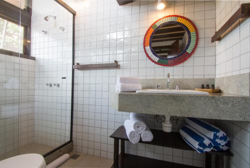a bathroom with a sink and a mirror at Pousada do Adriano in Búzios