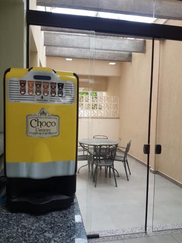 a yellow stove in a room with a table at Hospedaria Santo André in Sao Paulo