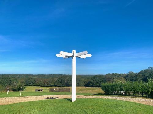 a white cross in the middle of a field at Stunning Estate sleeps 22 private parking & garden in Hailsham