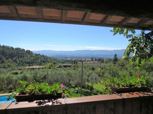 a view from the balcony of a house with flowers at Holiday Home Borgo La Cella-3 by Interhome in Pian di Scò