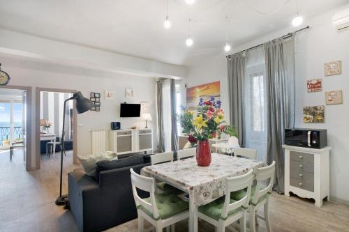 a living room with a table and a couch at Casa Raineri 200 mt dal mare in Imperia