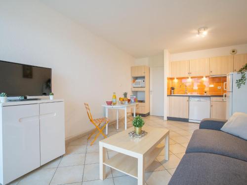 a living room with a couch and a table at Apartment Les Belles Plages-5 by Interhome in La Grande Motte