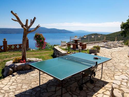 a blue ping pong table with a view of the water at Holiday Home Kristijana by Interhome in Martina