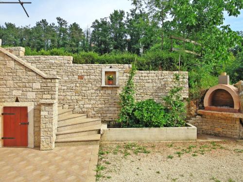 a stone wall with a door and a brick oven at Apartment Vinka - ROJ434 by Interhome in Žminj