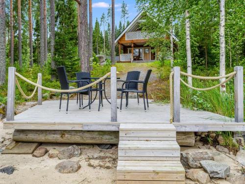 a wooden deck with chairs and a table on it at Holiday Home Rantakumpu by Interhome in Lieksa