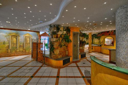 a building with a room with paintings on the walls at Hotel Meerane in Meerane
