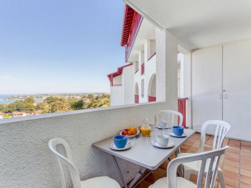een witte tafel en stoelen op een balkon bij Apartment Les Hauts de Bordagain-13 by Interhome in Ciboure