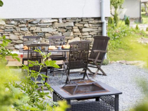 a patio with four chairs and a table at Holiday Home Brníčko by Interhome in Brníčko
