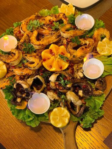 a plate of food with seafood and lettuce on a table at Resort Zerja and Spa in Peshkopi