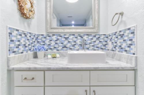 a bathroom with a sink and a mirror at Pirates Pointe Resort in Ruskin