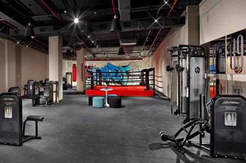 a gym with a red bench and a boxing ring at Wanda Vista Istanbul in Istanbul