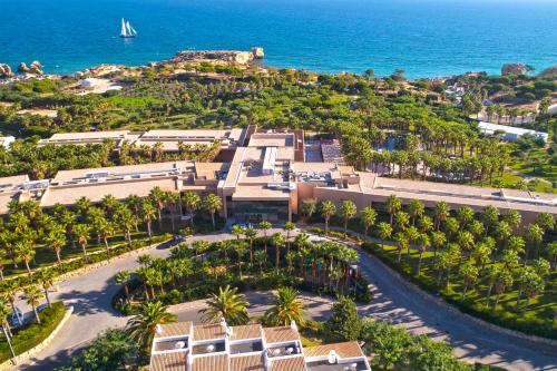 an aerial view of a resort with palm trees and the ocean at NAU Sao Rafael Atlantico in Albufeira