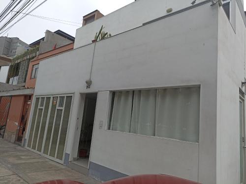 a white facade of a building on a street at Monterrico Suites Hotel in Lima